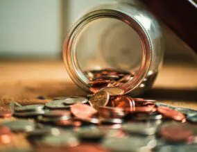 Money and coins spilt onto a table
