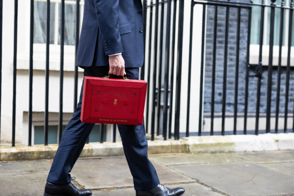 The Chancellor Jeremy Hunt walks outside Downing Street with the Budget box. Photo by Zara Farrar / HM Treasury
