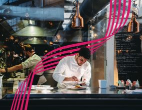 A chef is cooking in his restaurant's kitchen. High-end gourmet restaurant.