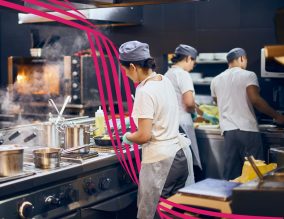 A team of cooks in a modern kitchen.