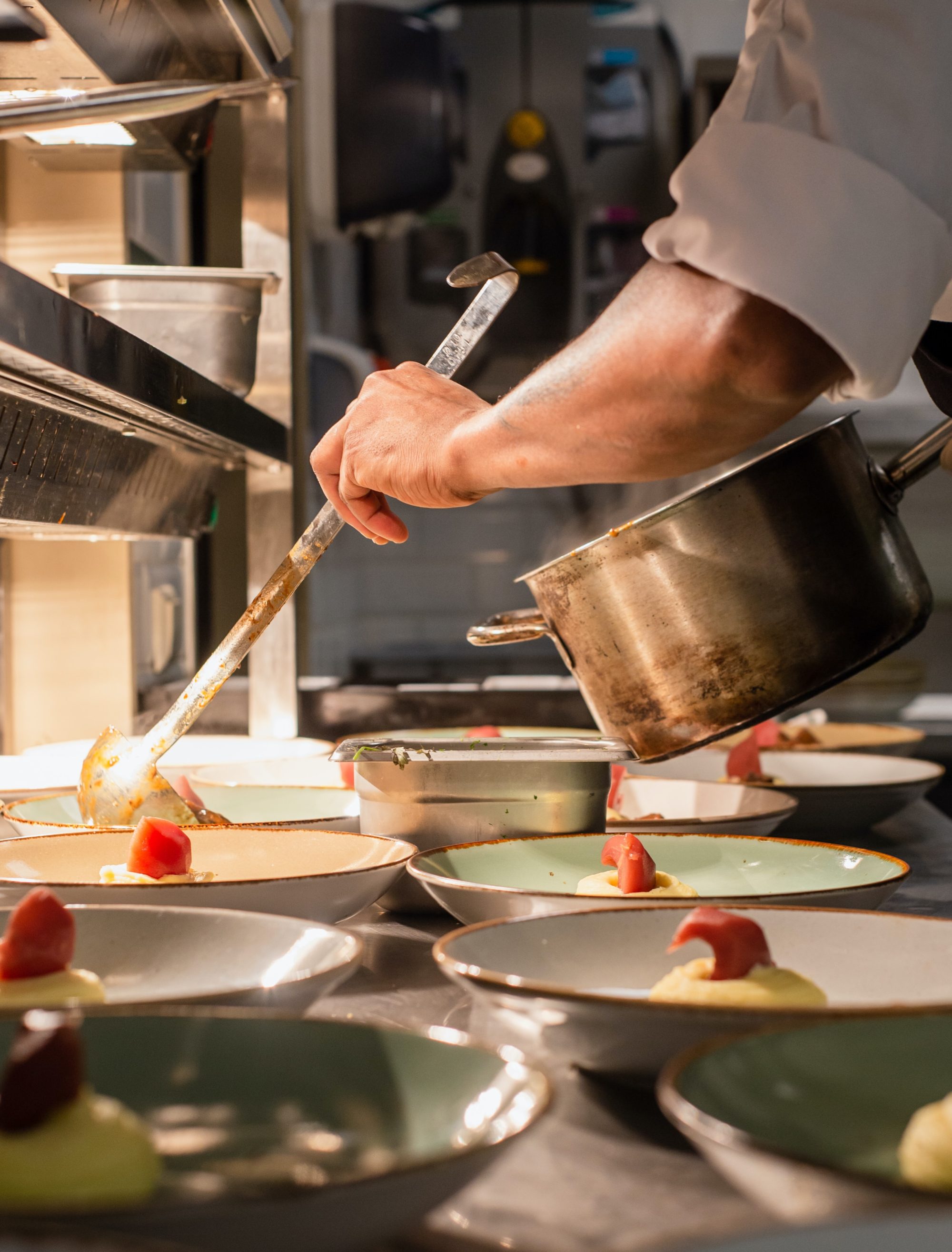 Chef serving food in a kitchen