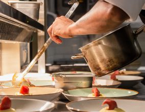 Chef serving food in a kitchen