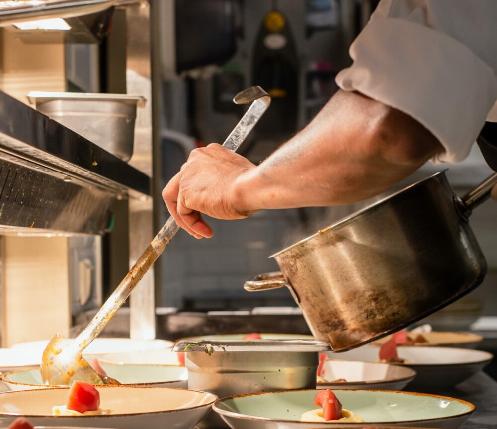 Chef serving food in a kitchen
