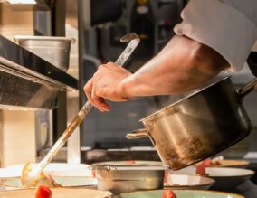 Chef serving food in a kitchen