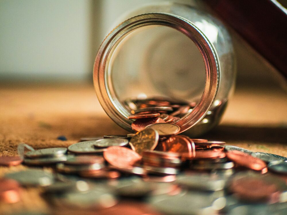 Money and coins spilt onto a table