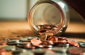 Money and coins spilt onto a table