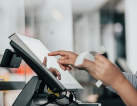 Team member using a till with receipt