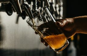 Pint of beer being poured in a pub