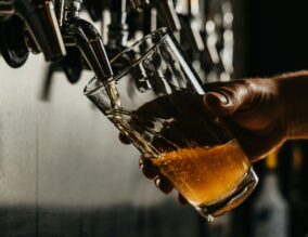 Pint of beer being poured in a pub